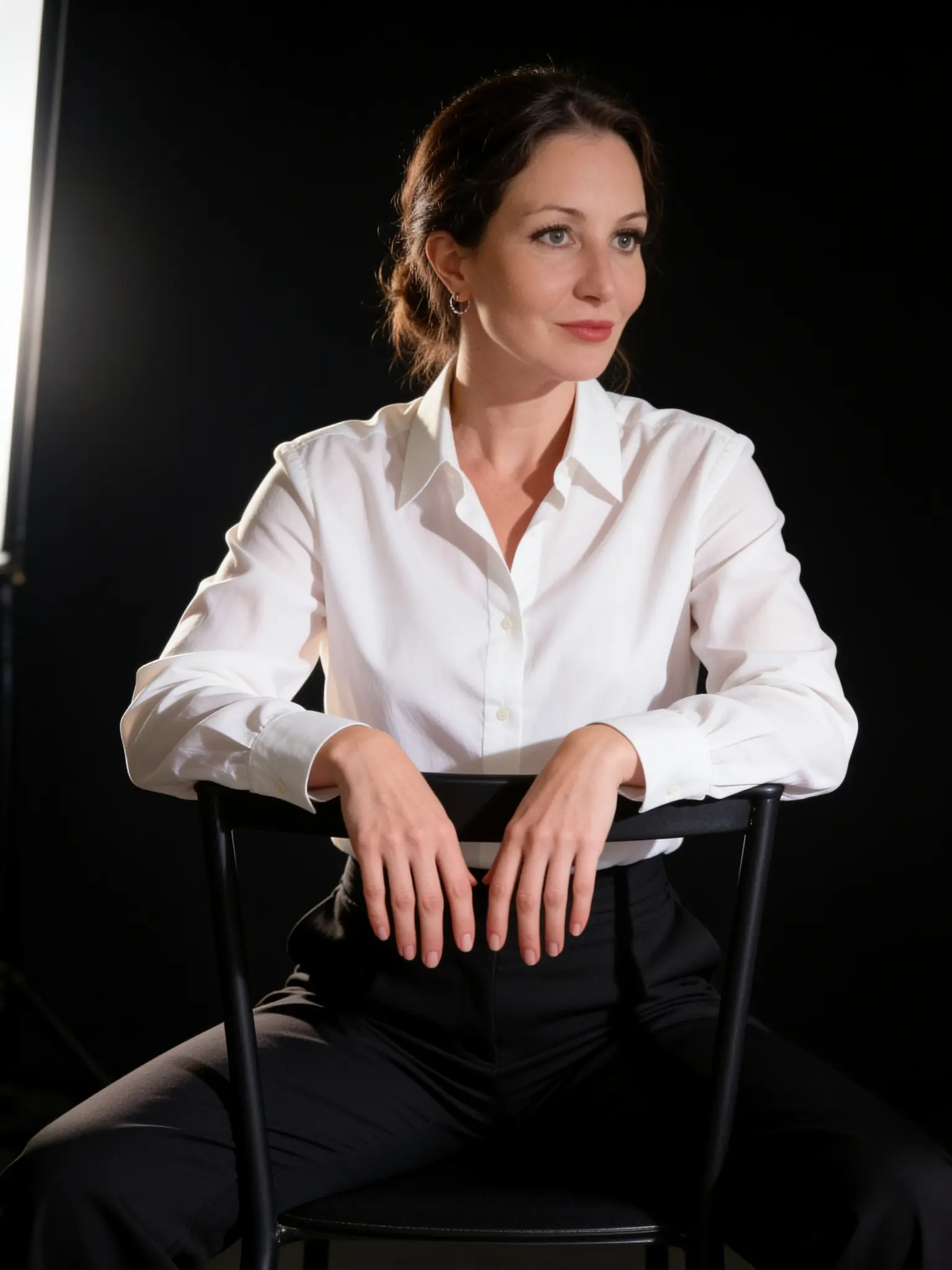 Lucy Hutchings Hunt with her hair up, seated in a white shirt, gazing thoughtfully into the light